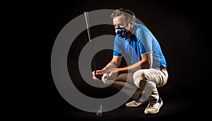 Golfer with COVID-19 mask, black background