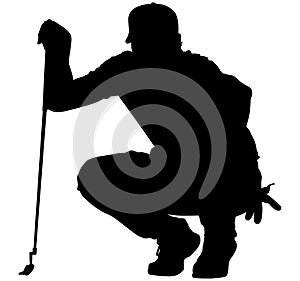 Golfer crouching on the golf course analyzing, planning the golf tee shot, golf swing with a golf club in hand. Golfer in a squat