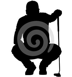 Golfer crouching on the golf course analyzing, planning the golf tee shot, golf swing with a golf club in hand. Golfer in a squat