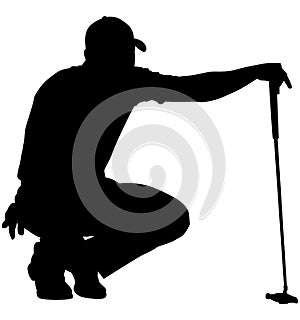 Golfer crouching on the golf course analyzing, planning the golf tee shot, golf swing with a golf club in hand. Golfer in a squat