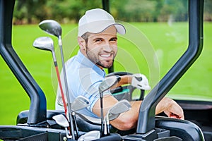 Golfer in golf cart.