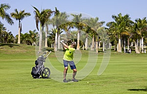 Golfer with golf club hitting the ball for the perfect shot