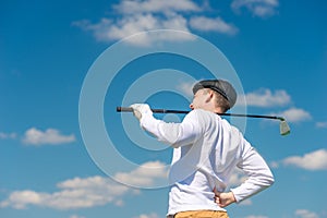 Golfer with a golf club rubs a sick back