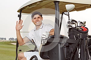 Golfer in golfcart with his clubs