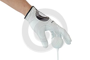 Golfer hand in white glove action with golf ball on tee with white background.