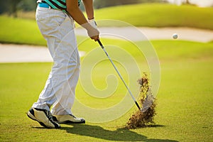 Golfer hitting ball with force. The grass distribution The blur of golf.Golfer hitting ball with force.