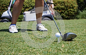 Golfer Hitting Golf Ball off Tee