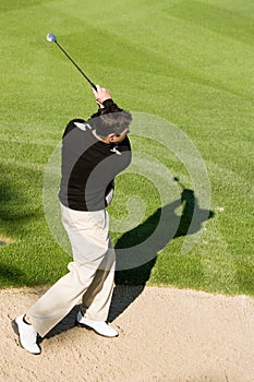 Golfer Hitting Golf Ball Out Of A Sand Trap