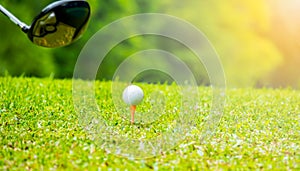 Golfer hitting golf ball on tee off zone in golf course