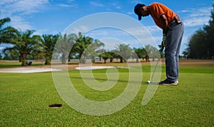 Golfer hitting golf shot with club on course vintage color tone, Man playing golf on a golf course in the sun