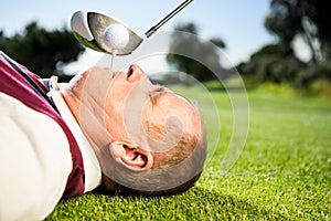 Golfer holding tee in his teeth