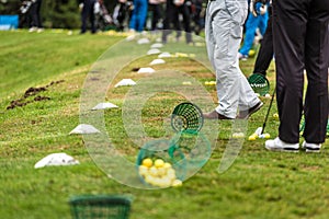 Golfer legs at golf tournament practice swing with golf club