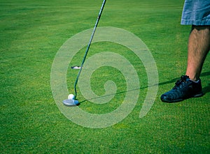 Golfer lining up his putt