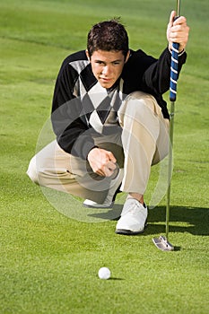 Golfer lining up putt