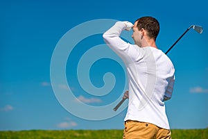 Golfer looking afar trajectory of flying his ball