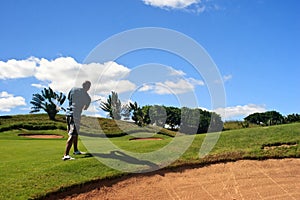 Golfer looking at the flying ball