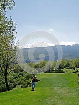 Golfer and Mount Etna