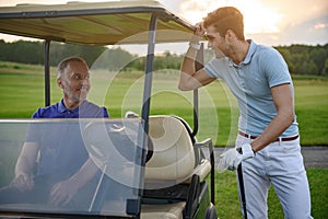 Golfer near golf cart