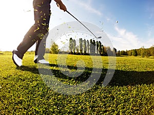 Golfer performs a golf shot from the fairway. photo