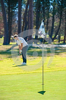 Golfer playing a chip shot onto the green