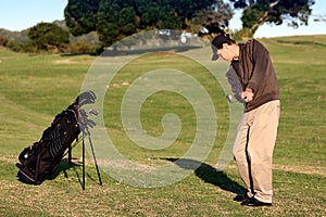 Golfer playing lob shot photo