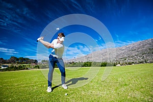 Golfer playing a shot on the fairway