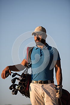 Golfer portrait at golf course on sunset
