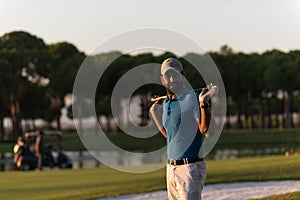 Golfer portrait at golf course on sunset