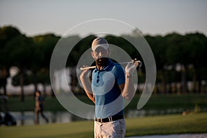 Golfer portrait at golf course on sunset