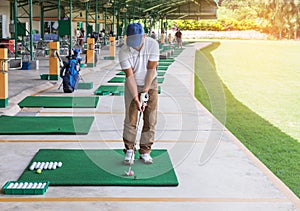 Golfer during practice driving range in golf course