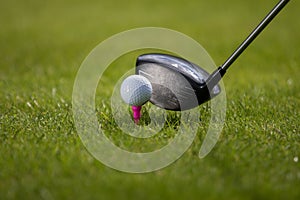 A golfer prepares to hit the club with a driver