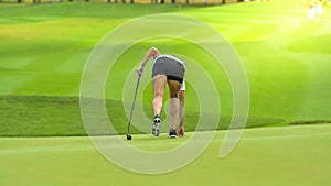 Golfer is pushing golf ball by golf club from tee boxes at golf course in competition game