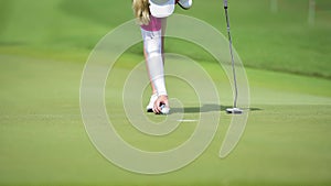 Golfer is pushing golf ball by golf club from tee boxes at golf course in competition game