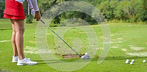 Golfer is pushing golf ball by golf club from tee boxes at golf course in competition game