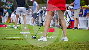 Golfer is pushing golf ball by golf club from tee boxes at golf course in competition game