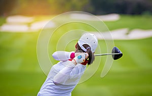 Golfer is pushing golf ball by golf club from tee boxes at golf course in competition game