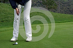 Golfer putting the ball