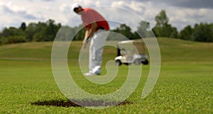 Golfer putting the ball photo