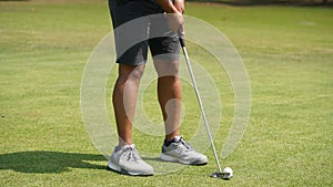 Golfer putting ball on the green golf