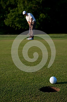 Golfer putting a golf ball