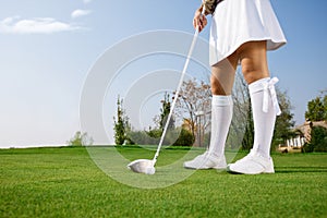 Golfer putting golf ball