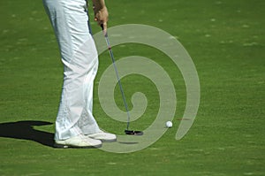 Golfer putting a golf ball