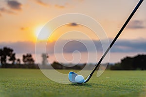 Golfer is putting golf ball on green grass at golf course for training to hole  with blur background a