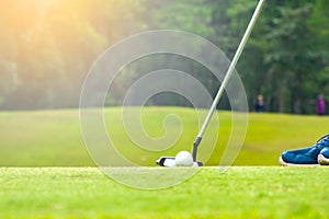 Golfer putting golf ball to hole for the winner