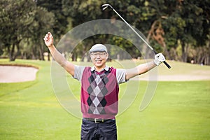 Golfer raising his arms