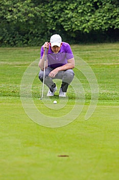 Golfer reading the green