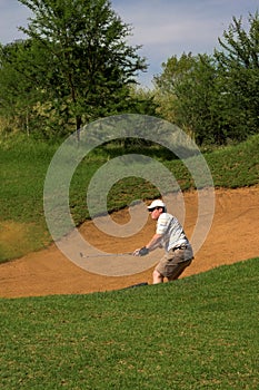 Golfer in the sand bunker.