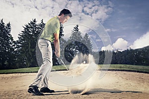 Golfer in sand trap.