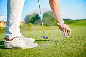 Golfer setting ball to strike