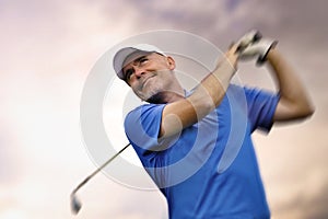 Golfer shooting a golf ball